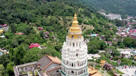 High-view-of-Kek-Lok-Si-Buddhist-temple-golden-pagoda-shrine-spire,-Aerial-drone-orbit-reveal-shot