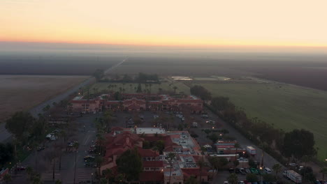 Flying-over-Harris-Ranch-in-California-with-the-beautiful-colors-of-sunrise-in-the-horizon