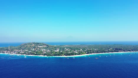 Aerial-view-of-Gili-Trawangan-tropical-island,-vacation-resorts-white-sandy-beach-surrounded-by-blue-azure-sea,-Indonesia