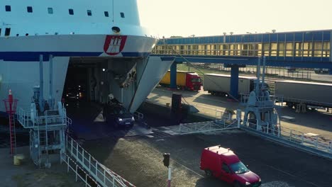 Aerial-view-of-vehicles-leaving-the-deck-of-a-sea-ferry-during-sunny-morning
