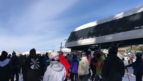 Tilt-Down,-Handheld-shot-of-Skiies-waiting-in-line-at-Brighton-Ski-Resort-in-Utah