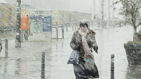 Single-Woman-on-the-Urban-Streets-of-Berlin-during-Strong-Blizzard