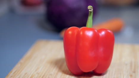 Red-Bell-Capsicum-On-A-Chopping-Board,-PAN-RIGHT