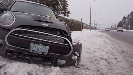 Front-view-of-damaged-vehicle-on-side-of-snowy-road-post-accident