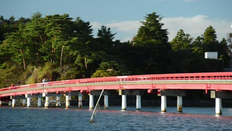 Red-Fukuurabashi-Bridge-leading-over-the-bay-of-Matshushima,-Japan