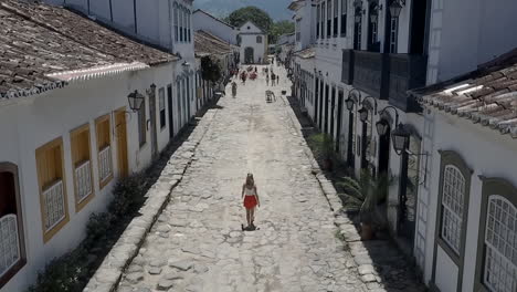 Woman-walking-through-the-streets-of-Paraty,-Brazil