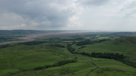 Aerial-shot-of-a-rural-landscape-on-the-North-West-coast-of-England,-bright-but-cloudy-day