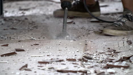 Jack-hammer-destroying-ceramic-tile-floor-in-slow-mo