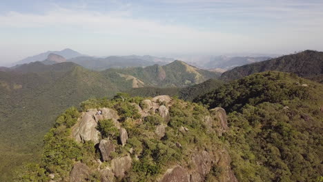 Aerial-of-hiker-on-Bonet-Rock-in-Petrópolis,-Rio-de-Janeiro,-Brazil