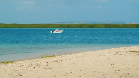 A-Local-Fishing-Boat-Anchored-At-The-Bay-In-Bonaire,-Kralendijk-On-A-Sunny-Day---wide-shot