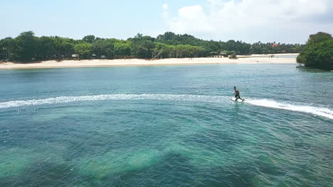Aerial-Tracking-Shot-Of-Male-Jetsurf-Rider-Having-Fun-At-Ocean-Resort