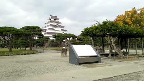Japanese-man-taking-a-photo-of-a-white-samurai-castle