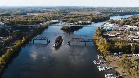 Great-overview-drone-shot-of-Arrigoni-Bridge-in-Middletown,-Connecticut-and-the-nearby-rotating-railway-bridge