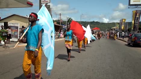 Flag-bearers-march-in-slow-motion-in-the-annual-Yam-Festival-in-Ho,-Ghana,-in-rural-west-Africa