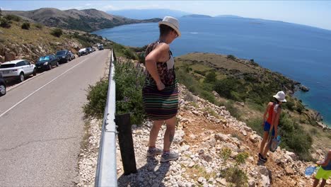 Woman-walks-her-way-to-stunning-beach-in-the-island-of-Krk,-Croatia