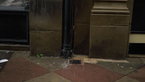 Water-splashing-into-pavement-after-storm-medium-shot