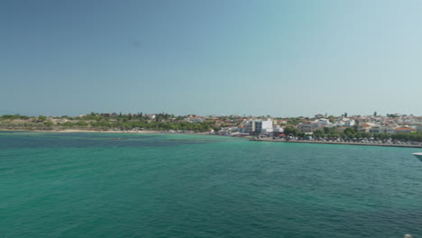 Pan-wide-shot-of-Port-of-Aigina,-view-from-ferry-boat-approaching-the-port-4K