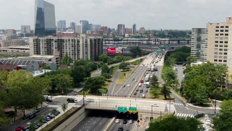 Aerial-establishing-shot-of-Philadelphia-skyline,-Vine-St,-Schuylkill-River,-Amtrak-Station,-Wawa-billboard