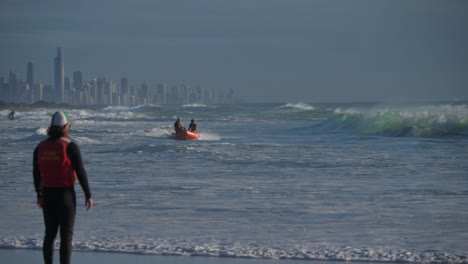 Volunteer-Lifeguard-Watching-His-Team-On-Inflatable-Rubber-Boats-Sailing-In-The-Ocean---Australian-Surf-Life-Saving-Team-On-A-Rescue-Boat---Currumbin,-Gold-Coast,-Australia