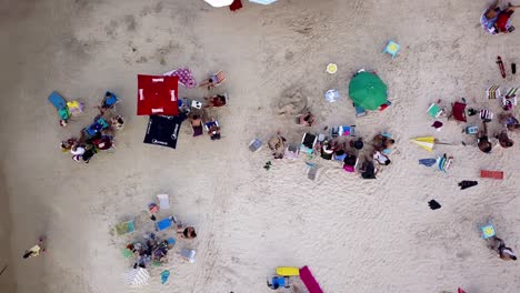 Aerial-top-down-shot-of-people-enjoying-on-a-crowded-beach-in-Brazil