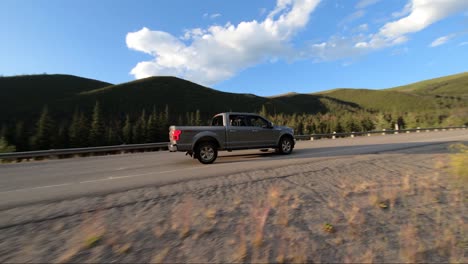 A-cinematic-drone-shot-of-a-truck-driving-on-the-highway-during-a-perfect-sunset