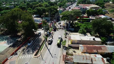 Aerial-view-of-people-cleaning-a-traffic-accident-scene,-in-Mexico-city,-Central-America---pull-back,-drone-shot