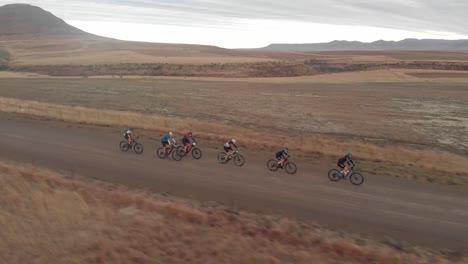 aerial-side-tracking-shot-following-mountain-bikers-during-a-gravel-race