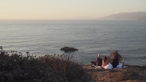 Family-Enjoys-a-Picnic-Near-the-Coastal-Shore-in-San-Francisco,-California-During-the-Sunset
