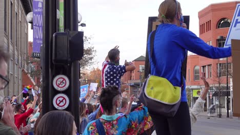 People-celebrating-Joe-Biden's-election-victory-in-the-streets-of-Boulder,-Colorado