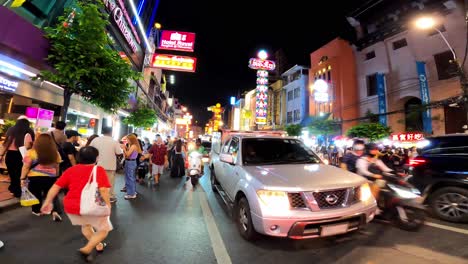 Time-lapse-footage-of-a-busy,-tourist-traffic-street-in-Bangkok,-Thailand-at-night