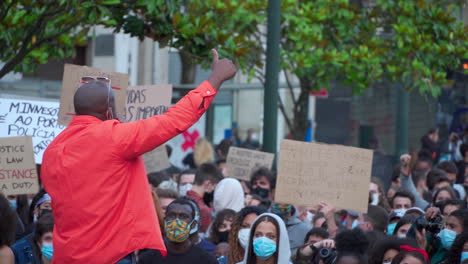 Porto-Portugal---june-6th-2020:-BLM-Black-Lives-Matter-Protests-Demonstration-man-adresses-the-cheering-crowd-with-a-microphone-in-his-hand-close-up