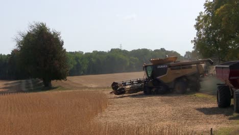 Farm-equipment-starting-up-and-harvesting-a-crop-on-a-sunny-day