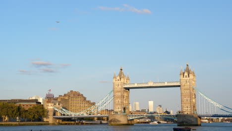 London-Tower-Bridge-and-Thames-on-a-Sunny-Day,-Aircraft-Flying-Above