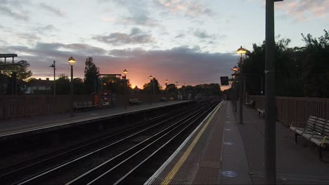 POV-Walking-Along-Train-Station-Platform-Against-Sunset-Skies