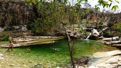 People-swim-and-cool-off-at-the-paradise-lost-waterfall-in-capitolio-MG