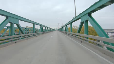 POV-driving-on-historical-2-lane-bridge-over-Mississippi-River-on-westbound-Interstate-I74,-connecting-Moline-IL-to-Bettendorf-IA
