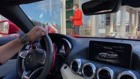 view-of-luxury-Puerto-Banus-driving-through-it-in-a-Mercedes-amg-gts-600hps-sports-car,-4k-panning-right-view-of-shops-and-yachts