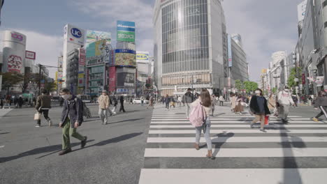 Pedestrians-Walk-At-Shibuya-Crossing-With-No-Tourists-During-The-Worldwide-Pandemic-In-Tokyo,-Japan