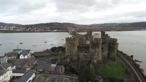Historical-medieval-Conwy-castle-landmark-aerial-view-pull-back-slow-left