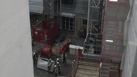 Workers-Waiting-For-Construction-Elevator-At-Site-In-Millbank