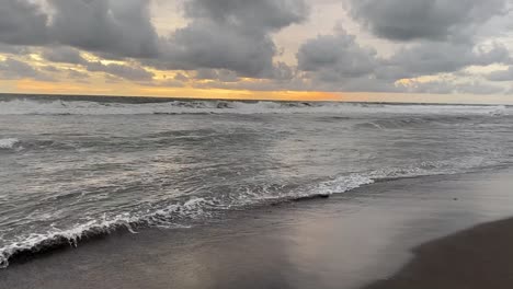 Cloudy-Sky-Over-Crashing-Waves-At-Seashore-Beach-In-Indonesia-During-Sunset