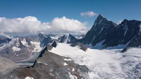 Aeriale-Shot-of-the-Swiss-Alps-in-the-Bern-region-with-the-Finsteraarhorn-peak-in-the-mountain-range-of-Wallis