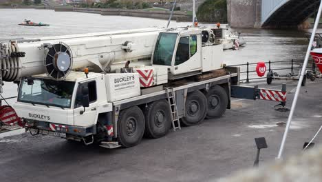 Hydraulic-crane-vehicle-machinery-on-Conwy-Wales-harbour-close-up-dolly-left