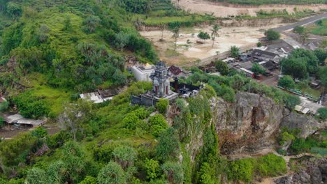 Picturesque-Buddhist-temple-located-on-cliff-on-shore-of-Java,-Indonesia,-aerial