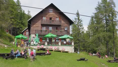 Aerial-view-of-tourists-enjoying-summer-day-at-mountain-hut