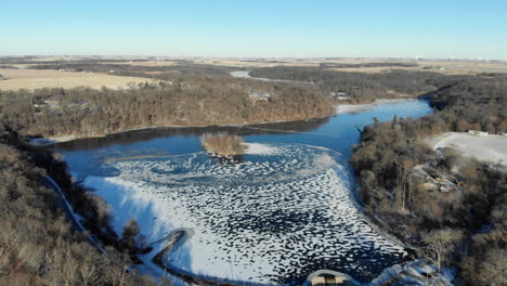 Aerial-video-flying-high-above-a-frozen-Pine-Lake-State-Park-in-Eldora-Iowa