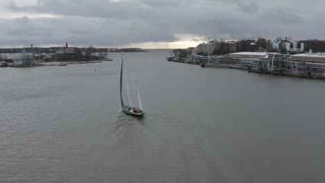 Drone-footage-of-sailing-boat-on-the-sea-water-near-the-city-coast-and-Finland-border