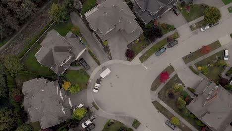 Drone-4K-Footage-over-Cloverdale-Urban-Housing-for-Middle-Class-Citizens-Zoned-City-Planning-Rotating-Shot-above-Cul-de-Sac-with-truck-pulling-a-trailer