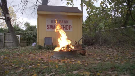 large-fire-in-fire-ring-back-yard-shed-slow-motion-flames