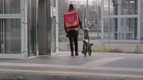 Food-Raider-Looks-at-Camera-and-Goes-to-Wait-a-Train-on-the-Platform-at-the-Station